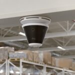 Ring Elite 4K security camera mounted on ceiling in warehouse with 360-degree field of view